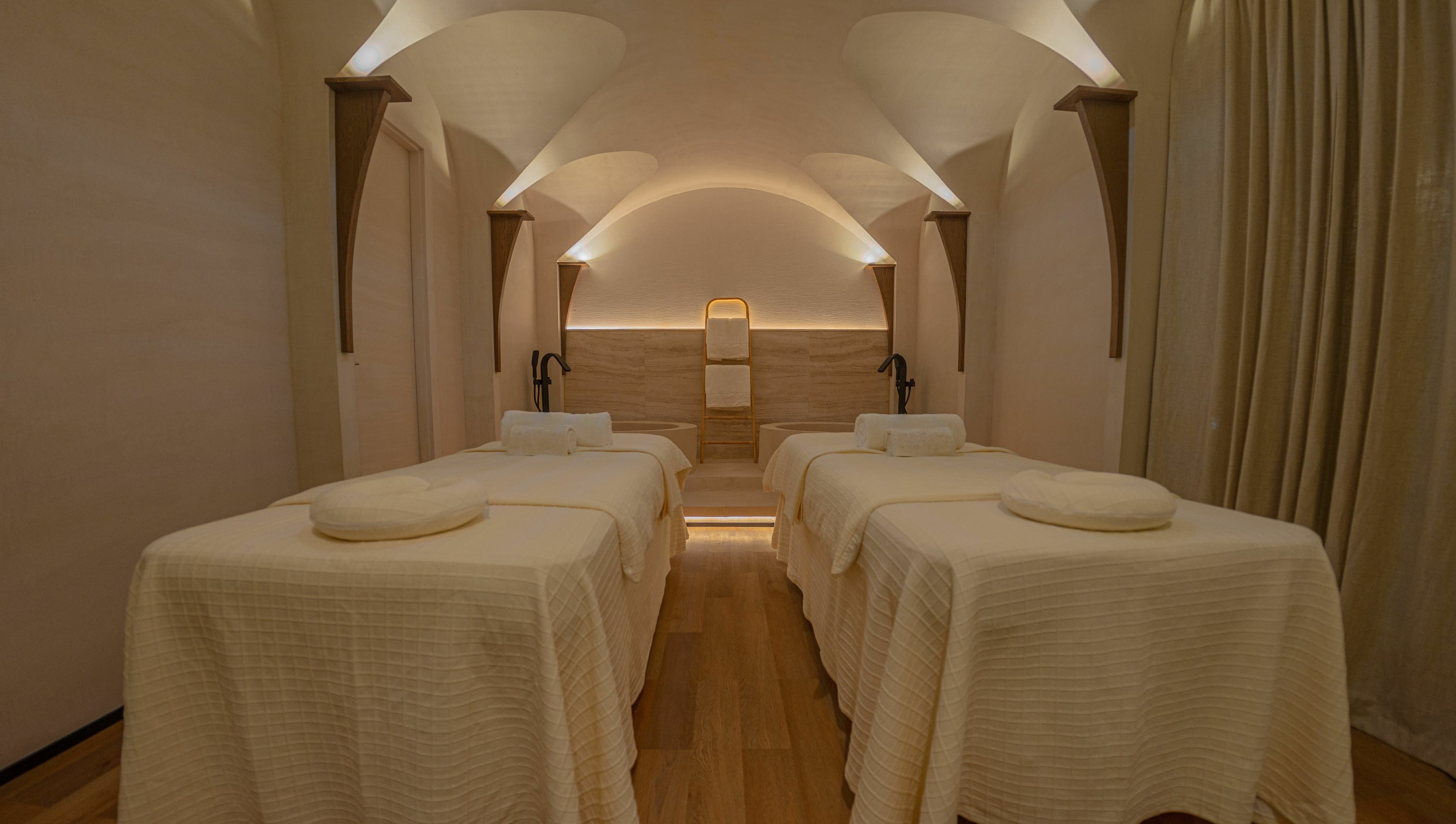 Luxurious spa room at Another Mars, Dubai, Dubai, AE with four massage beds under a vaulted ceiling.