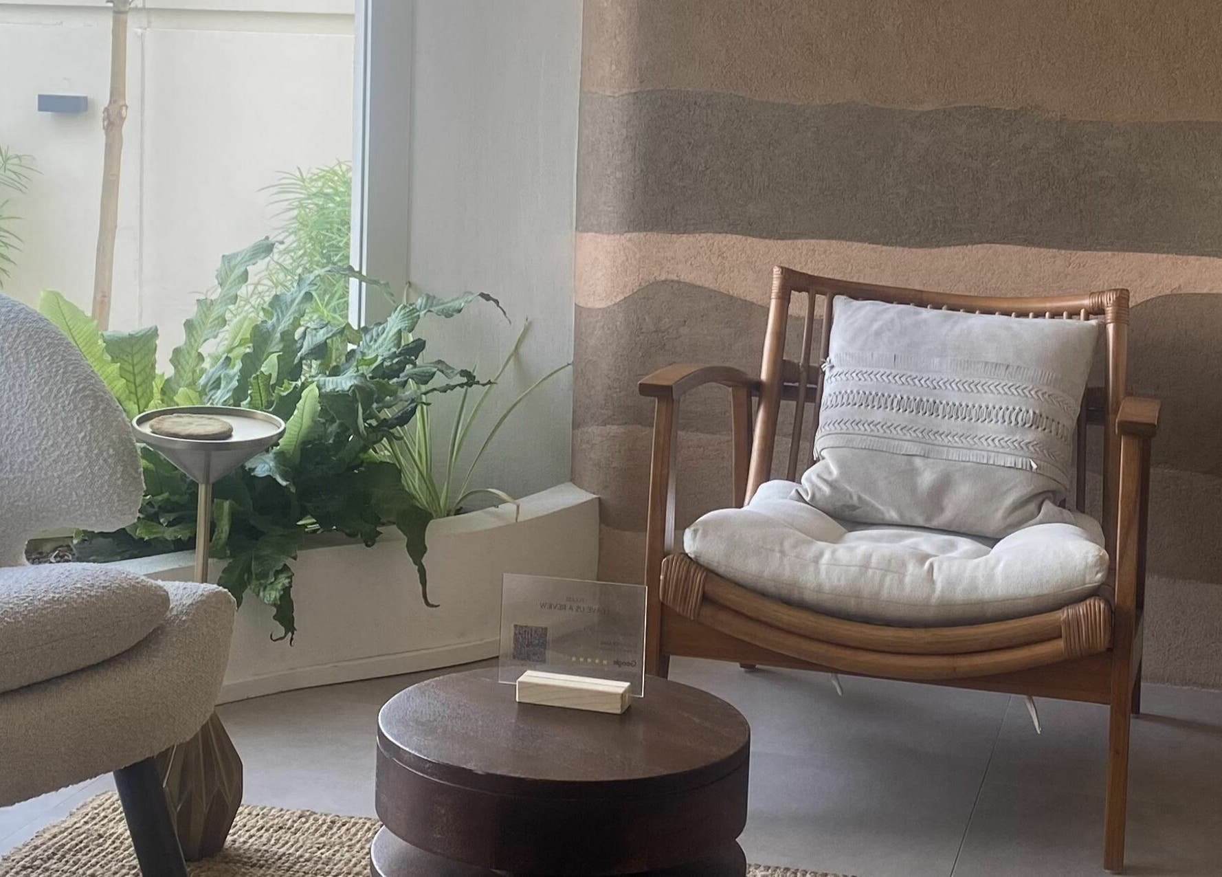 Relaxing seating area with plush chairs and plants at Another Mars, Dubai, Dubai, AE.