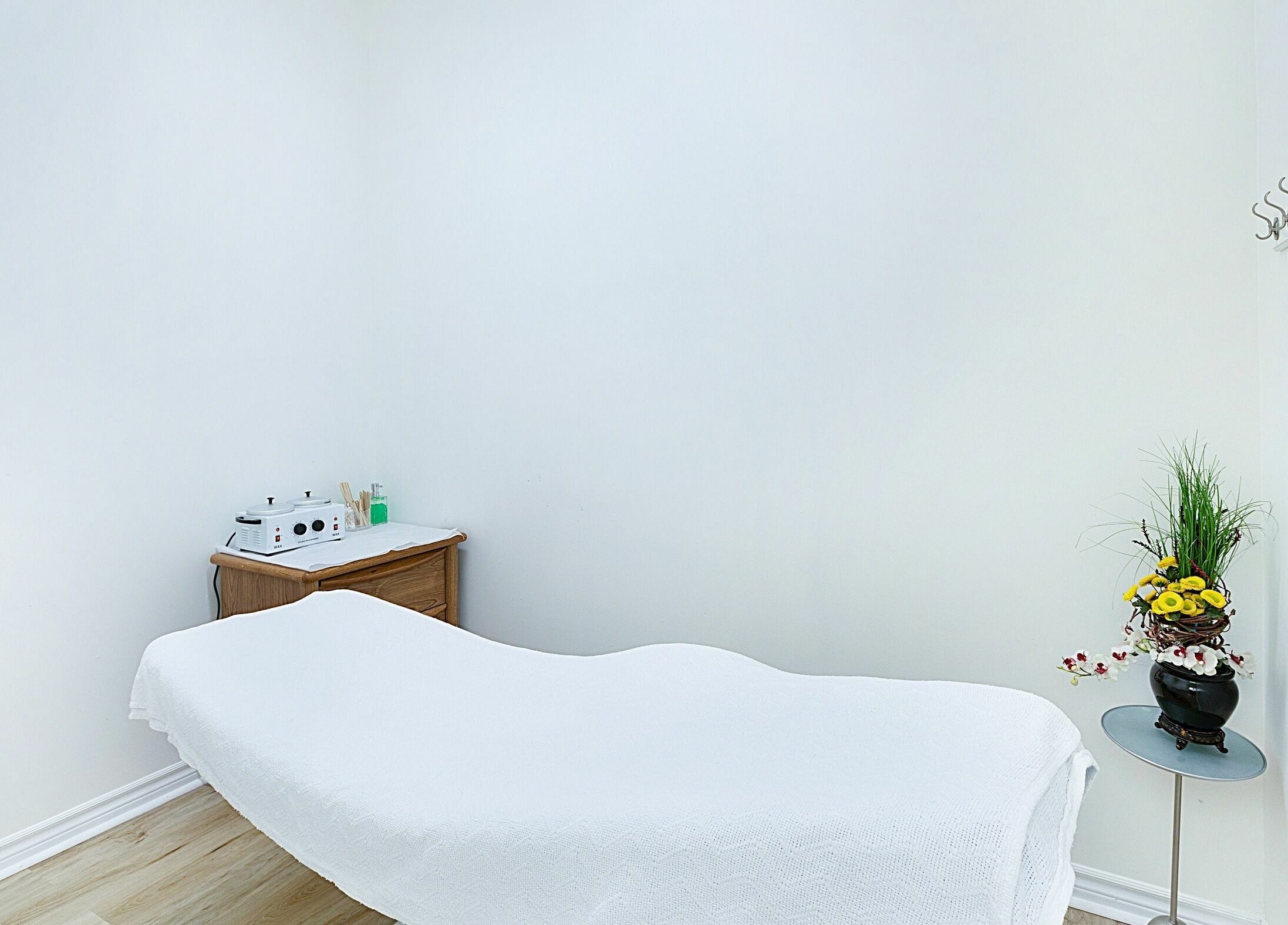 Relaxing treatment room at Divine Day Spa in Ottawa, Ontario, CA, featuring a massage table and elegant decor.