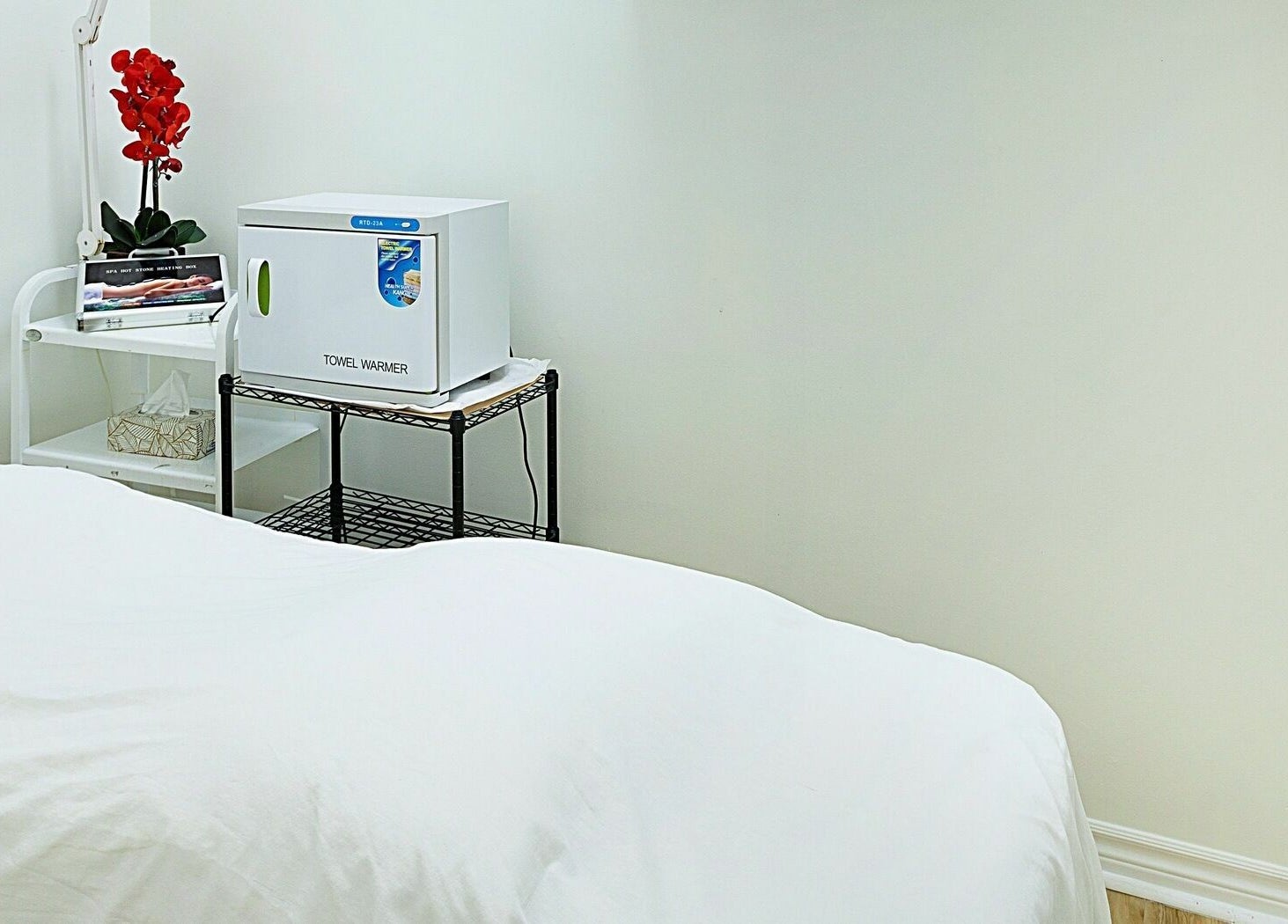 Relaxing treatment room at Divine Day Spa, Ottawa, Ontario, CA, featuring a towel warmer and elegant decor.