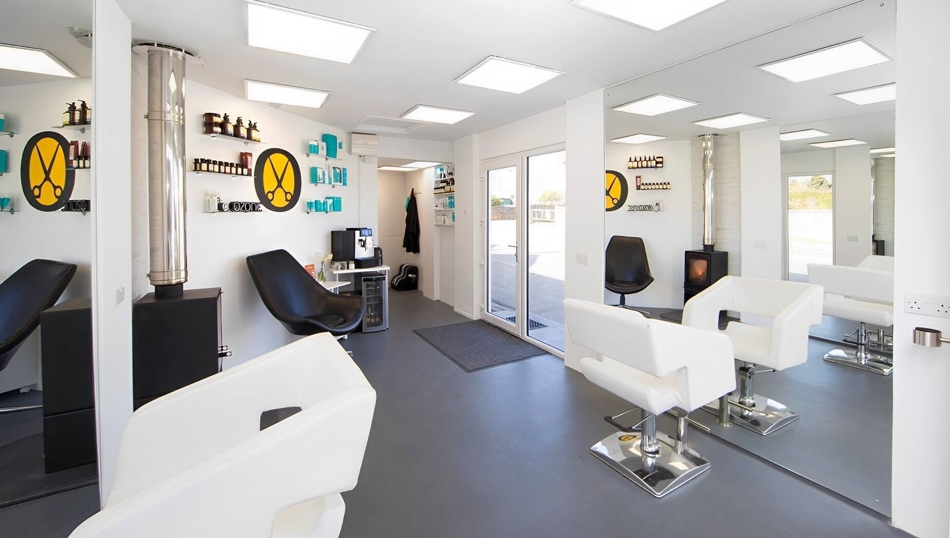 Modern salon interior at Ozone in Truro, England, GB, featuring sleek white and black decor.
