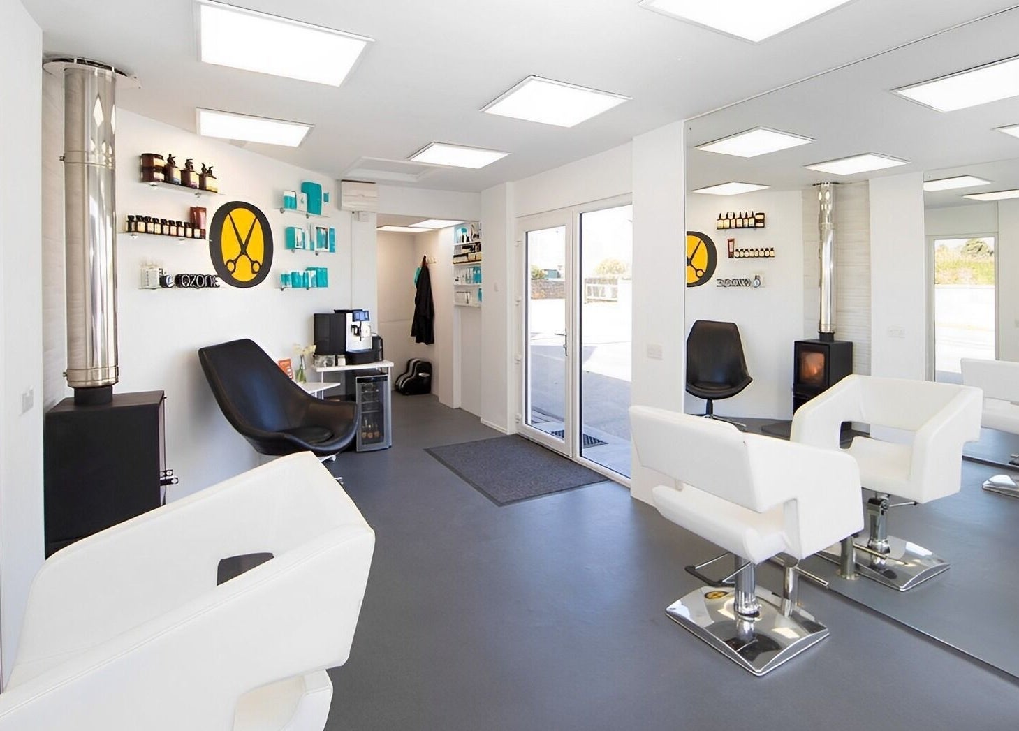 Modern salon interior at Ozone in Truro, England, GB, featuring sleek white and black decor.