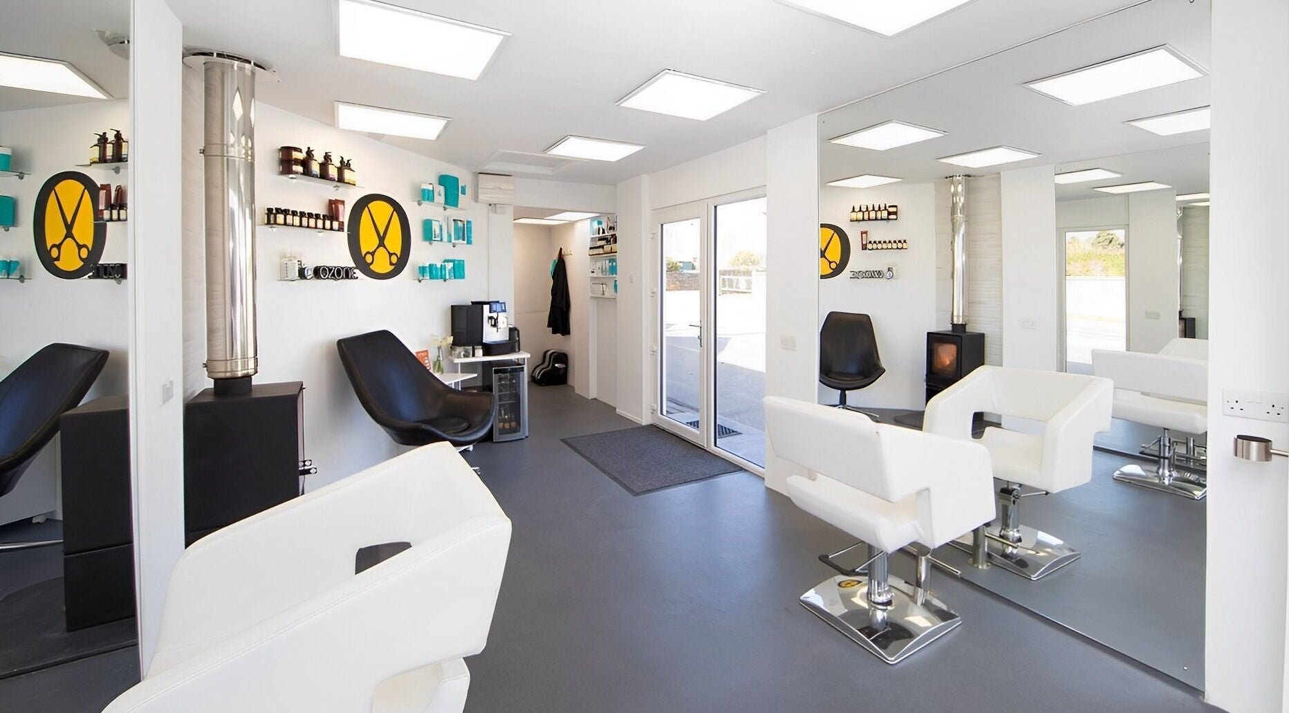 Modern salon interior at Ozone in Truro, England, GB, featuring sleek white and black decor.