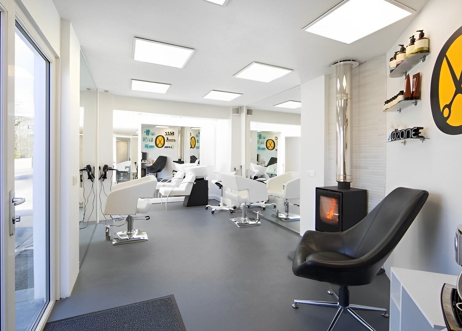 Interior of Ozone salon in Truro, England, GB featuring modern chairs, mirrors, and hair products.