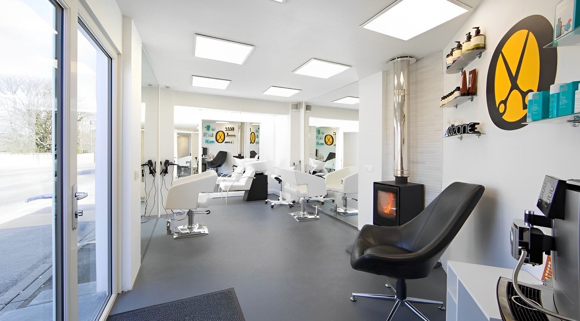 Interior of Ozone salon in Truro, England, GB featuring modern chairs, mirrors, and hair products.