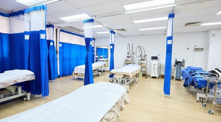 Spacious treatment room at Atchara's Clinic, Haymarket, New South Wales, AU with professional equipment and privacy curtains.