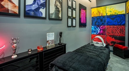 Modern skincare treatment room at Dr Alisha Skin, Leeds, England, GB, featuring vibrant decor and comfortable setup.