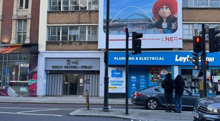 Street view by Sprinkle Of Magic Lashes - Shoreditch in London, England, GB, showcasing nearby shops.