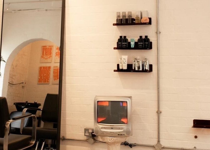 Stylish interior of Studio Studios with a retro TV, decor, and mirrors in London, England, GB.