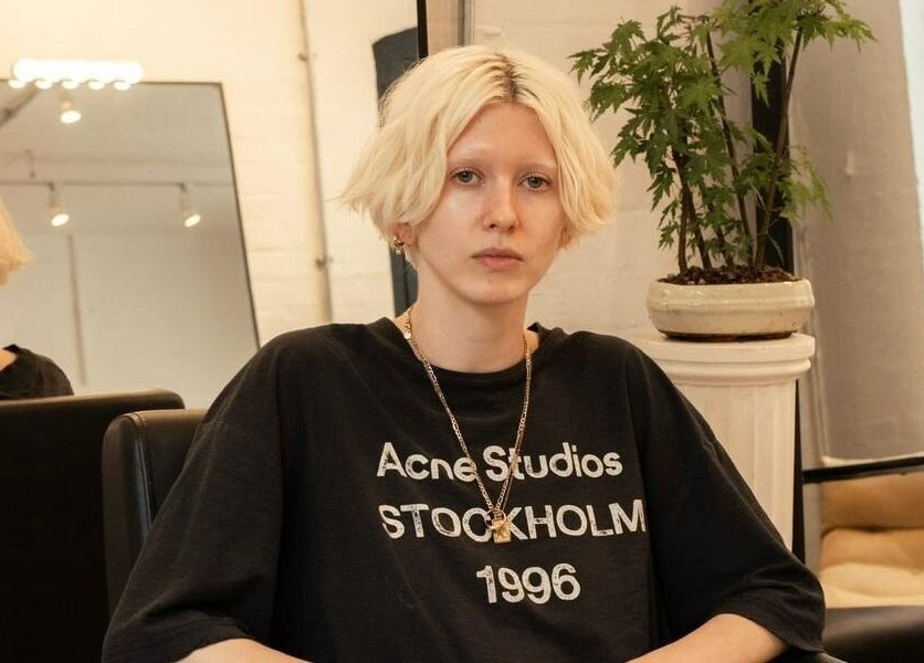 Person in chic setting at Studio Studios, London, England, GB. Modern decor with natural light accentuates elegance.