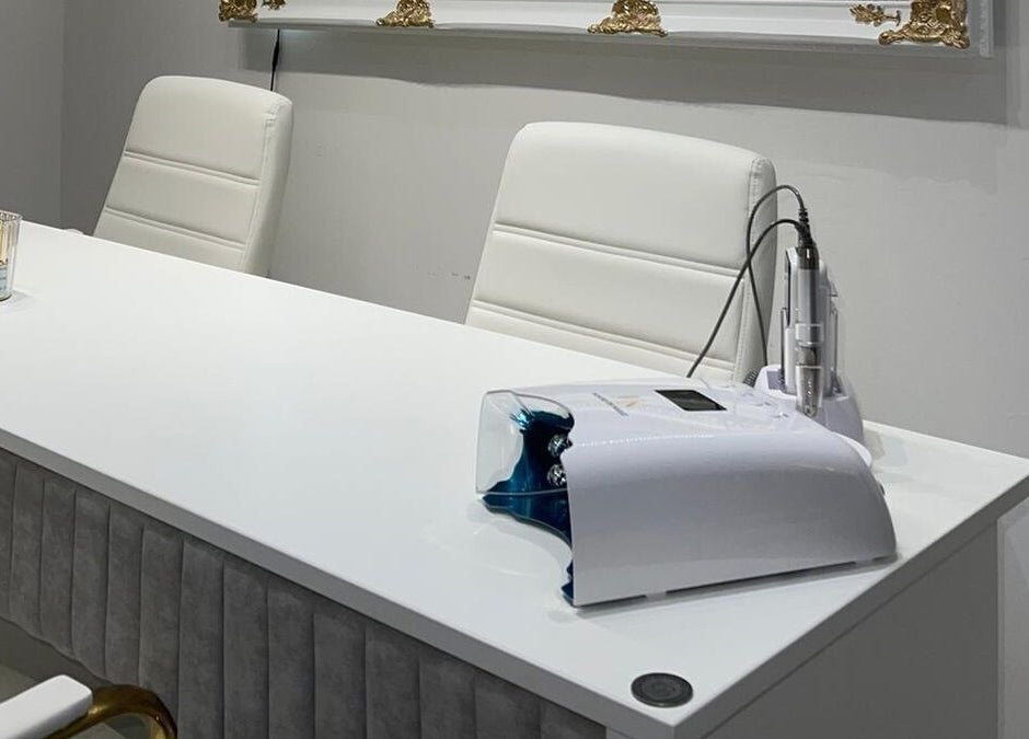 Modern nail station at House of Nailz™ in Dunstable, England, GB, featuring chic white decor and nail care tools.