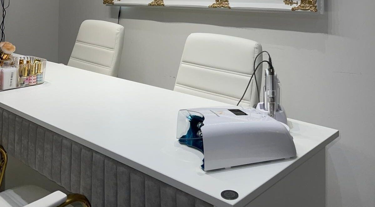 Modern nail station at House of Nailz™ in Dunstable, England, GB, featuring chic white decor and nail care tools.