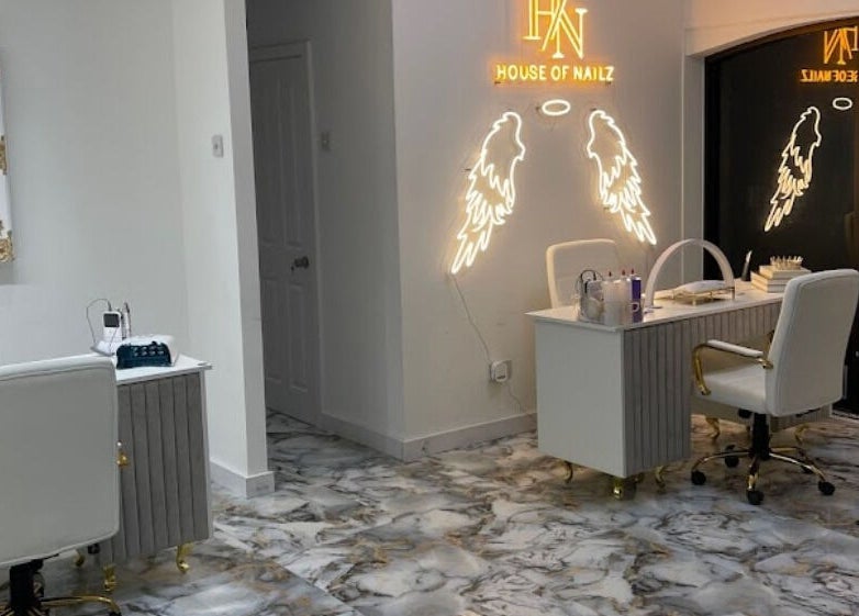 Chic nail salon interior at House of Nailz™ in Dunstable, England, GB showcasing elegant design and nail polish array.