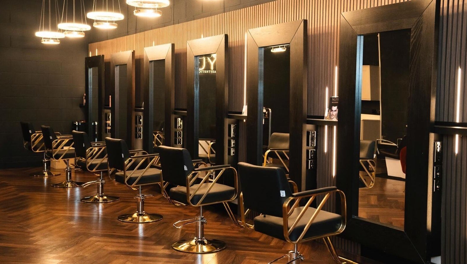 Sleek salon chairs and mirrors at NUYU Hair, Beauty and Aesthetics, Middlesbrough, England, GB.