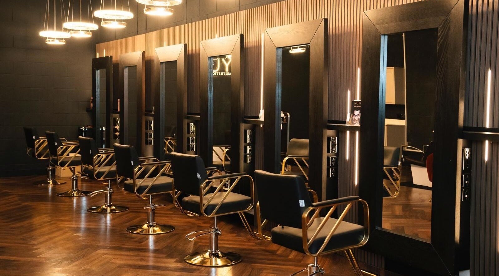 Sleek salon chairs and mirrors at NUYU Hair, Beauty and Aesthetics, Middlesbrough, England, GB.