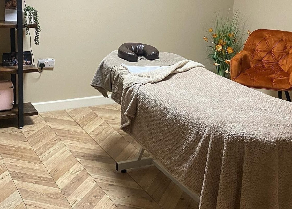 Cozy treatment room at NUYU Hair, Beauty and Aesthetics, Middlesbrough, England, GB featuring a massage table.