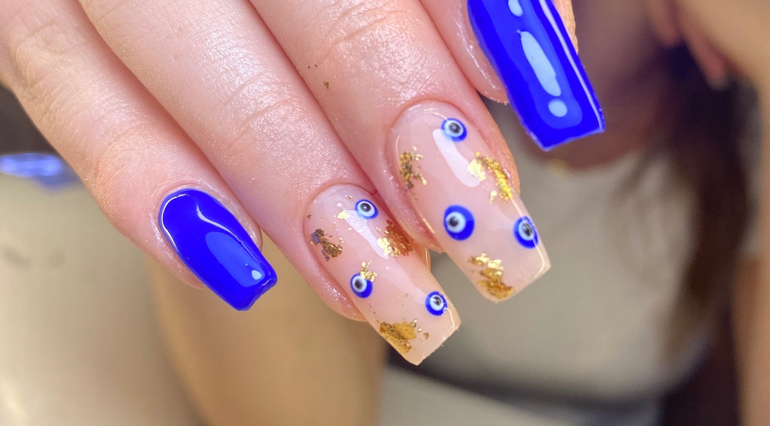 Detailed nail art with blue and gold accents at Karen's Beauty, Hadath, Mount Lebanon Governorate, LB.