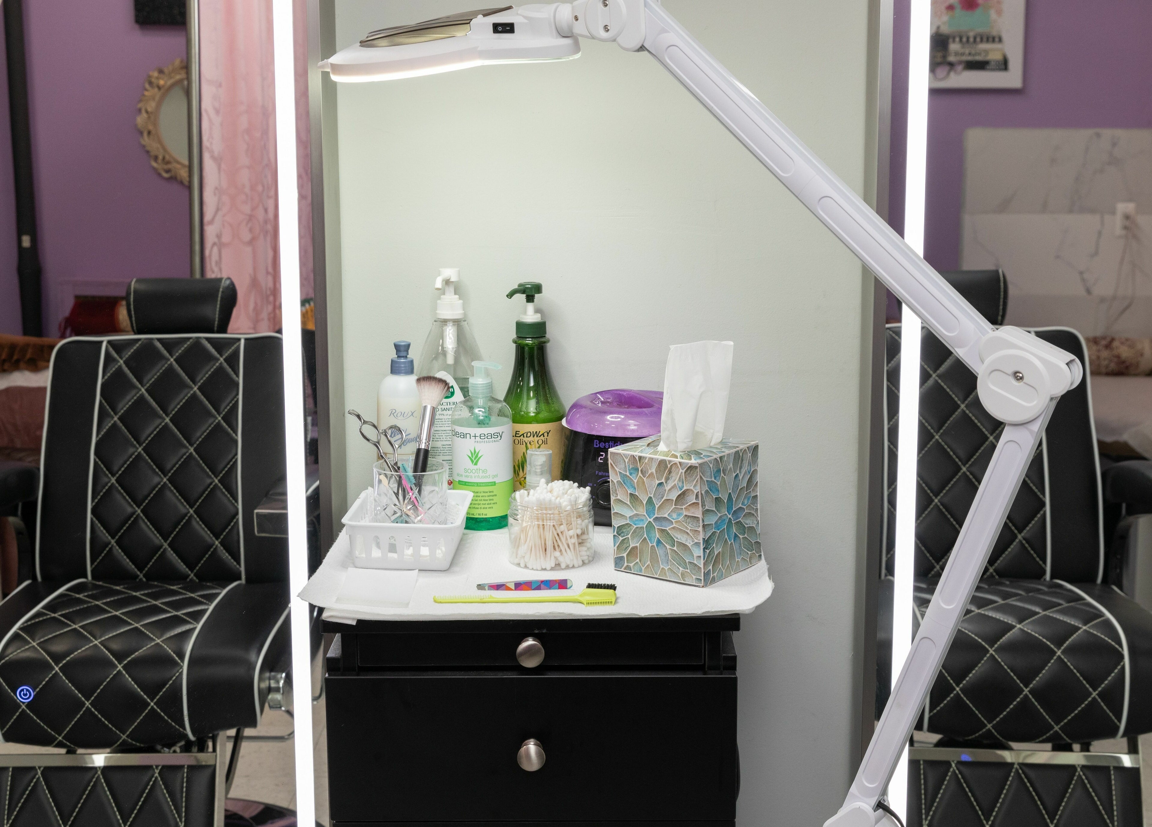 A beauty station at Wonder Lash Studio Queens, Long Island City, US with reclining chairs and skincare products.
