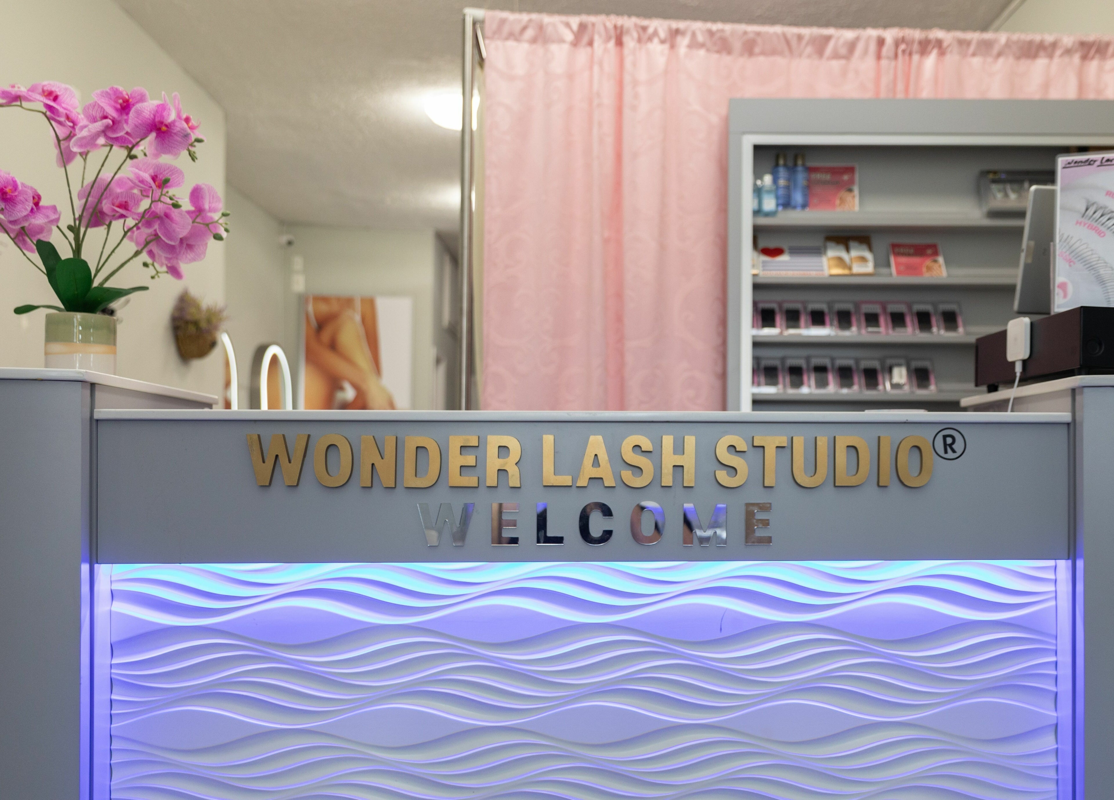 Reception area at Wonder Lash Studio Queens, Long Island City, US, featuring elegant pink and purple decor.