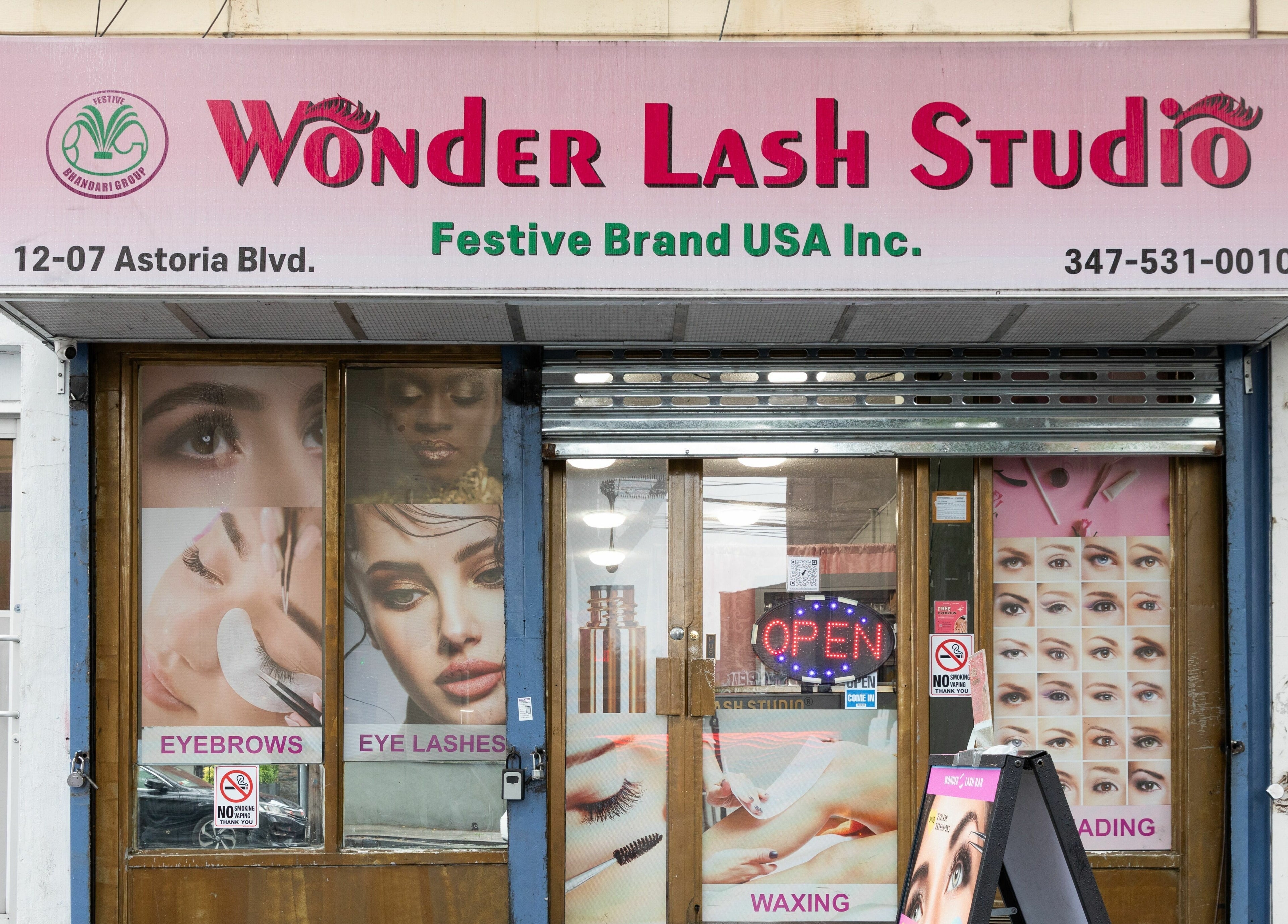Wonder Lash Studio Queens storefront at Long Island City, US, featuring beauty service posters.