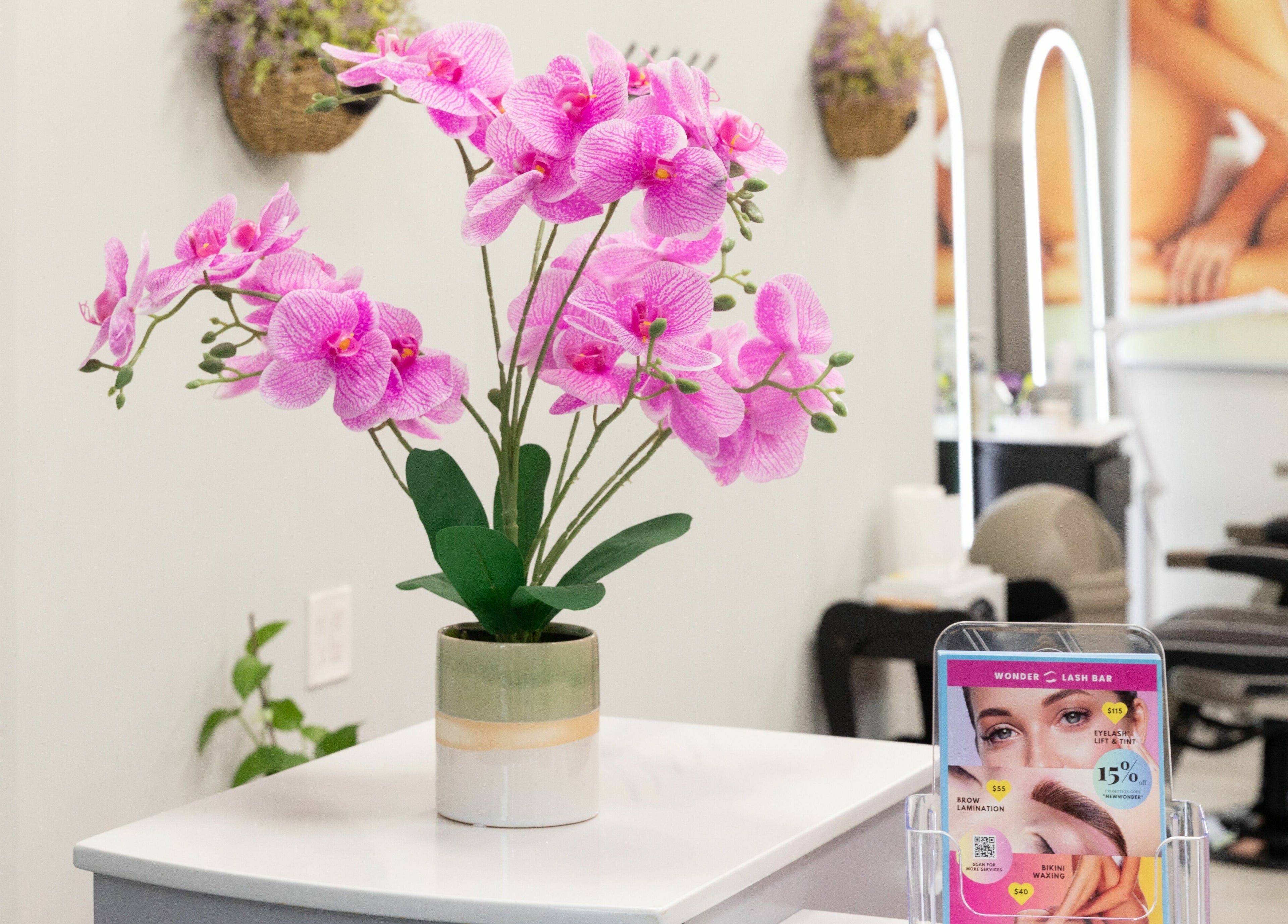 Lush pink orchids adorn the reception of Wonder Lash Studio Queens in Long Island City, United States, US.