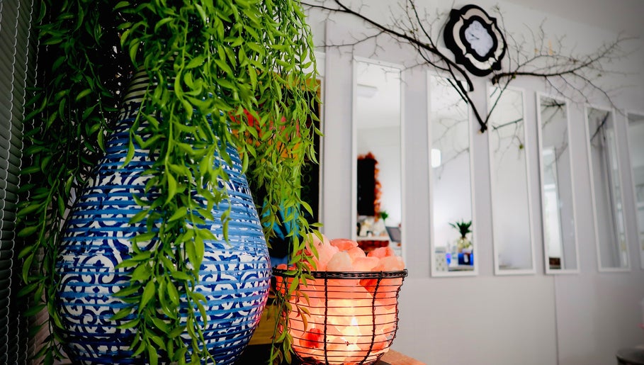 Peaceful decor at Boon Massage & Healing, Arlington, Massachusetts, featuring vibrant plants and a glowing salt lamp.