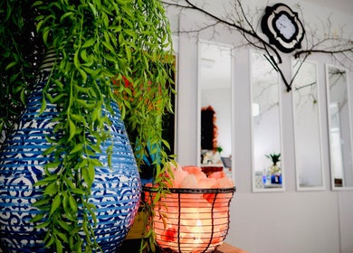 Peaceful decor at Boon Massage & Healing, Arlington, Massachusetts, featuring vibrant plants and a glowing salt lamp.