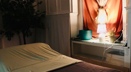 Serene massage room at Boon Massage & Healing in Arlington, Massachusetts, US, with calming decor and warm lighting.