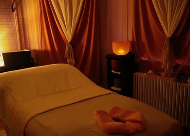 Cozy massage room at Boon Massage & Healing in Arlington, Massachusetts, US with soft lighting and warm decor.