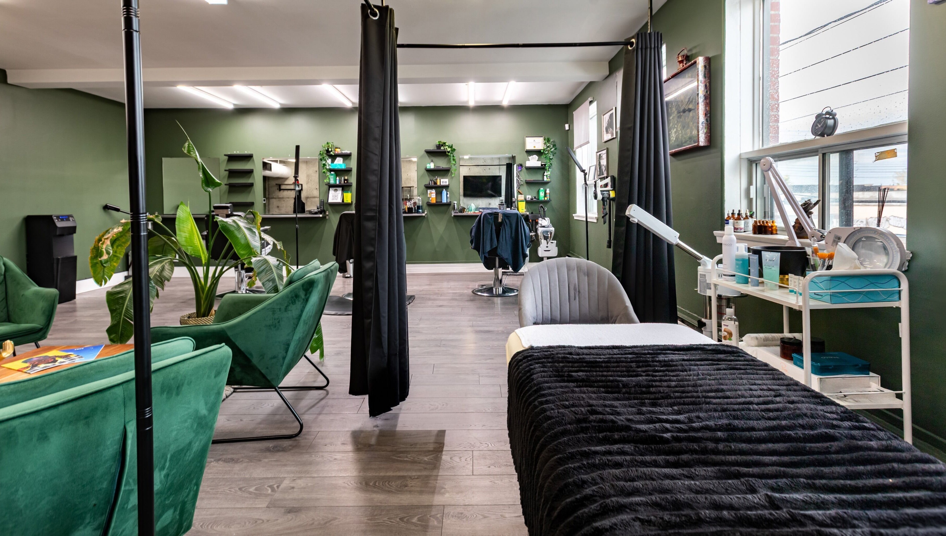 Inviting spa interior at Quantum Field Studio in Montréal, Québec, CA featuring green seating and dark decor.