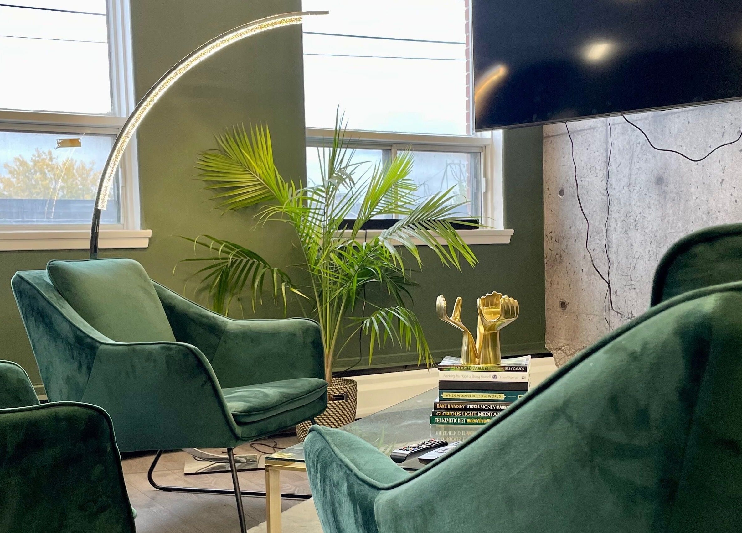 Elegant green chairs and plants in a calming space at Quantum Field Studio, Montréal, Québec, CA.