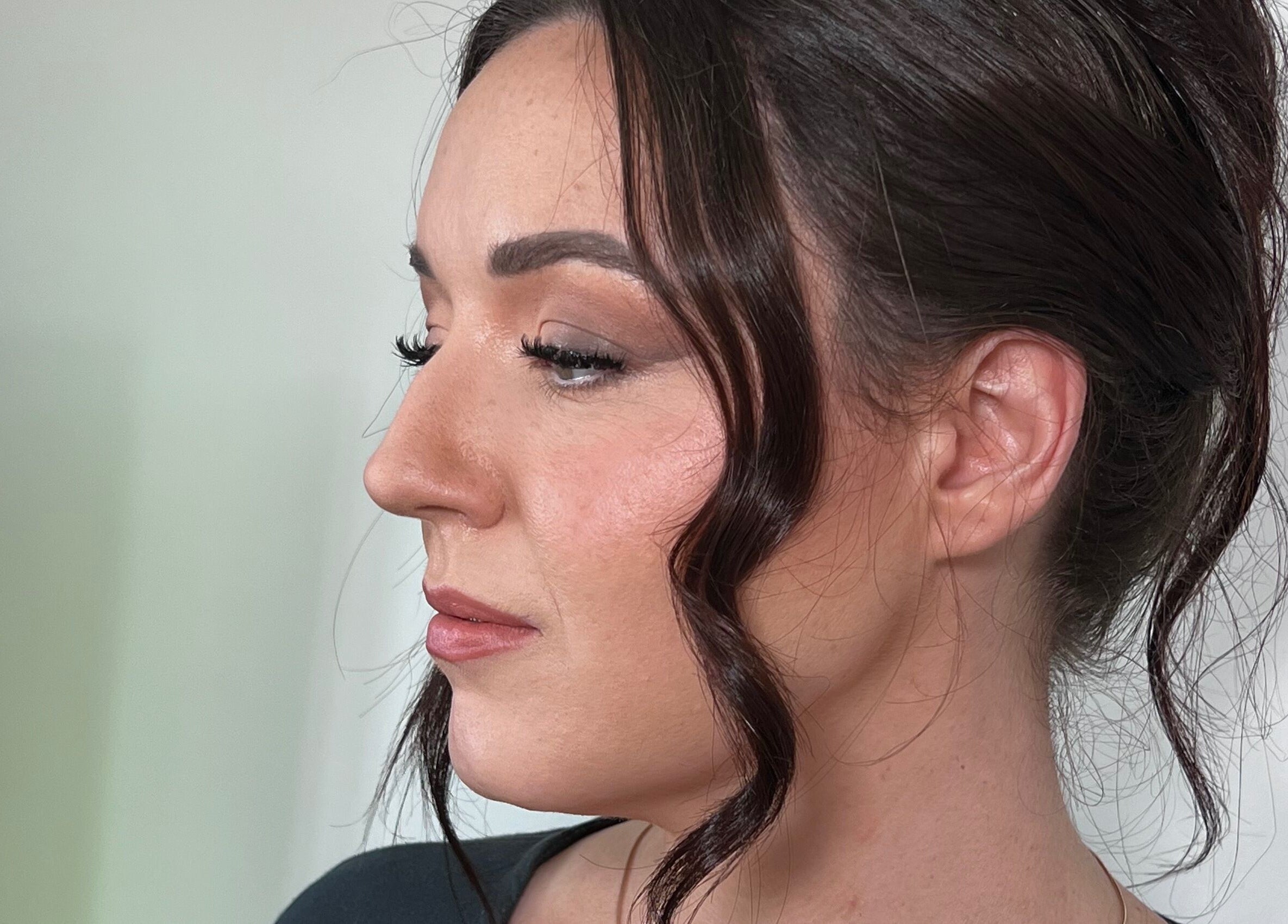 Elegant side profile of a woman with styled hair at The Lux Look, Banyo, Queensland, AU.