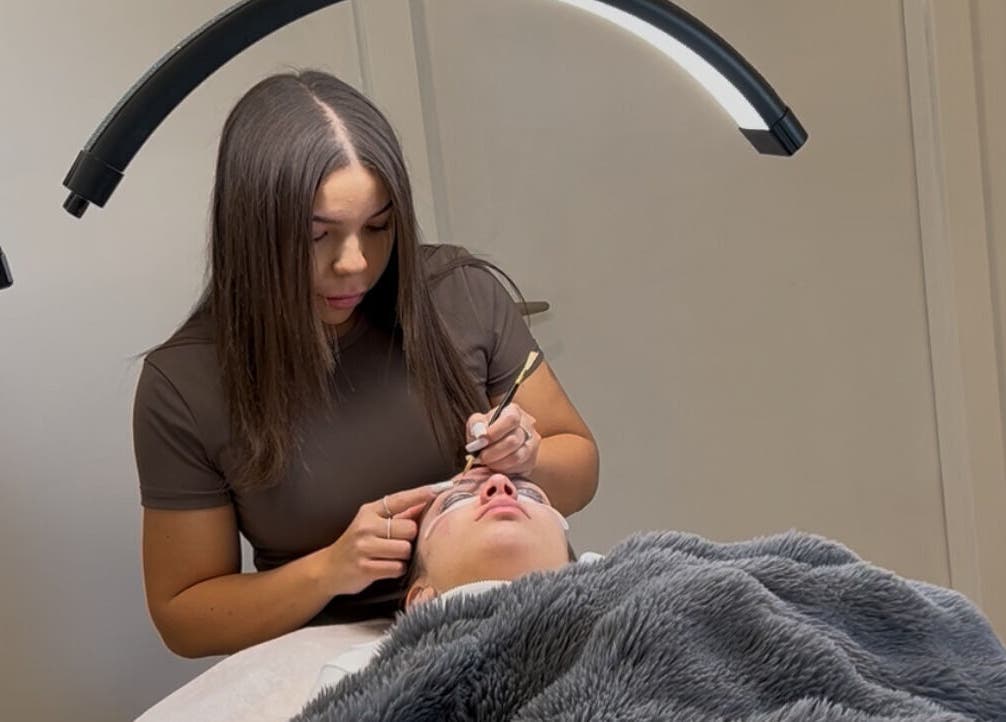 Expert applying eyelash extensions at Onlylashessx, Green Valley, New South Wales, AU under a soft light.