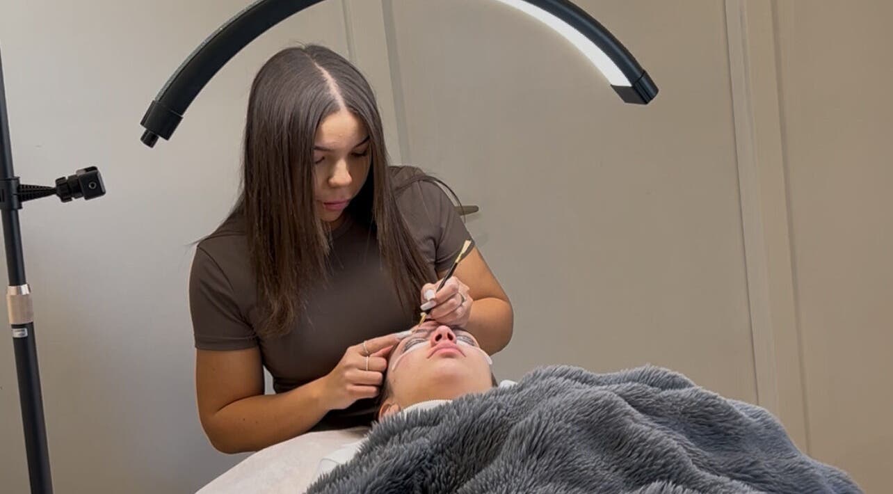 Expert applying eyelash extensions at Onlylashessx, Green Valley, New South Wales, AU under a soft light.