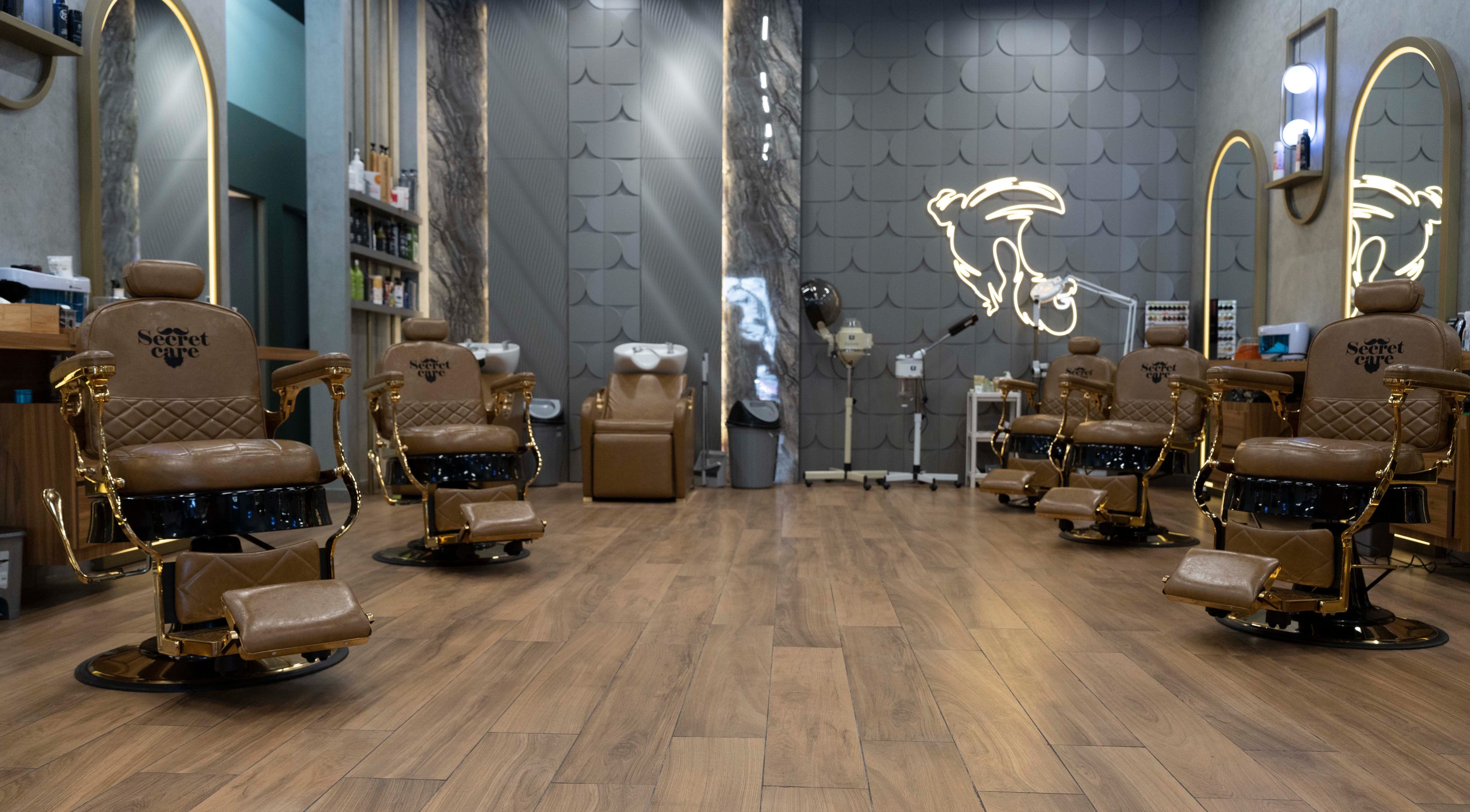 Interior of Secret Care barber Shop in Sharjah, featuring elegant leather chairs and stylish decor.