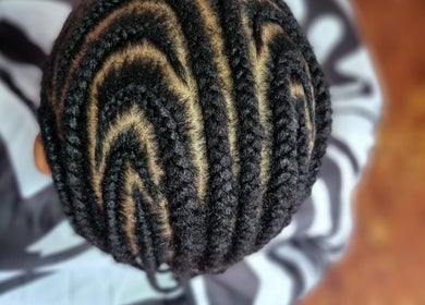 Intricate cornrow braids at Enhle Afro Salon in Mthatha, Eastern Cape, ZA, showcasing expert hairstyling.