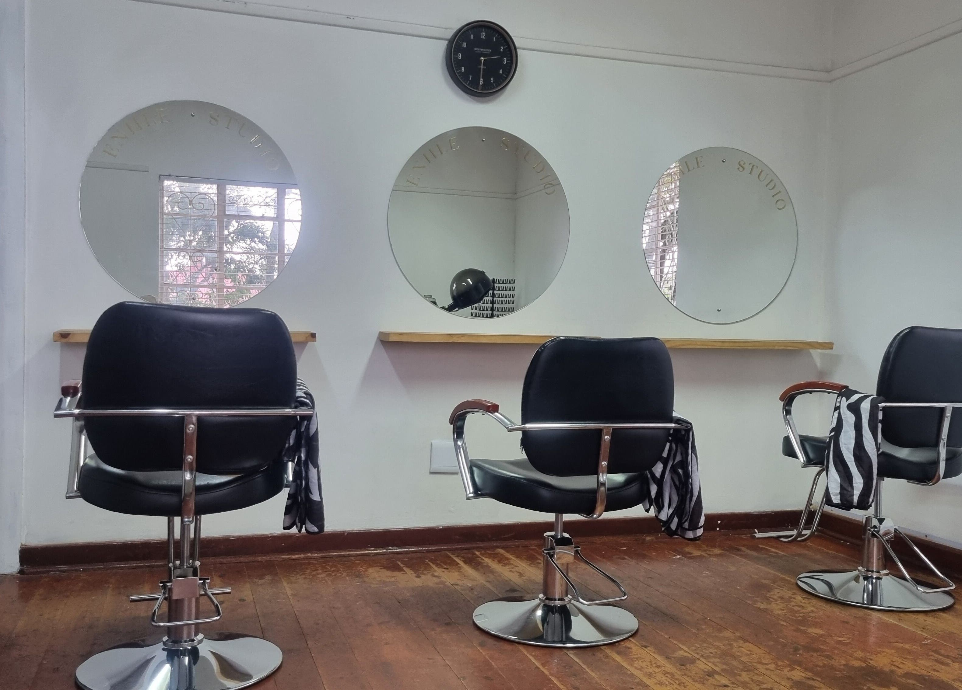 Stylish salon chairs at Enhle Afro Salon in Mthatha, Eastern Cape, ZA. Modern mirrors and sleek design.