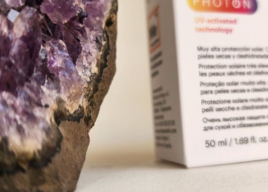 Close-up of amethyst crystals next to skincare product at Sattva Aesthetics in Kralendijk, Bonaire, BQ.