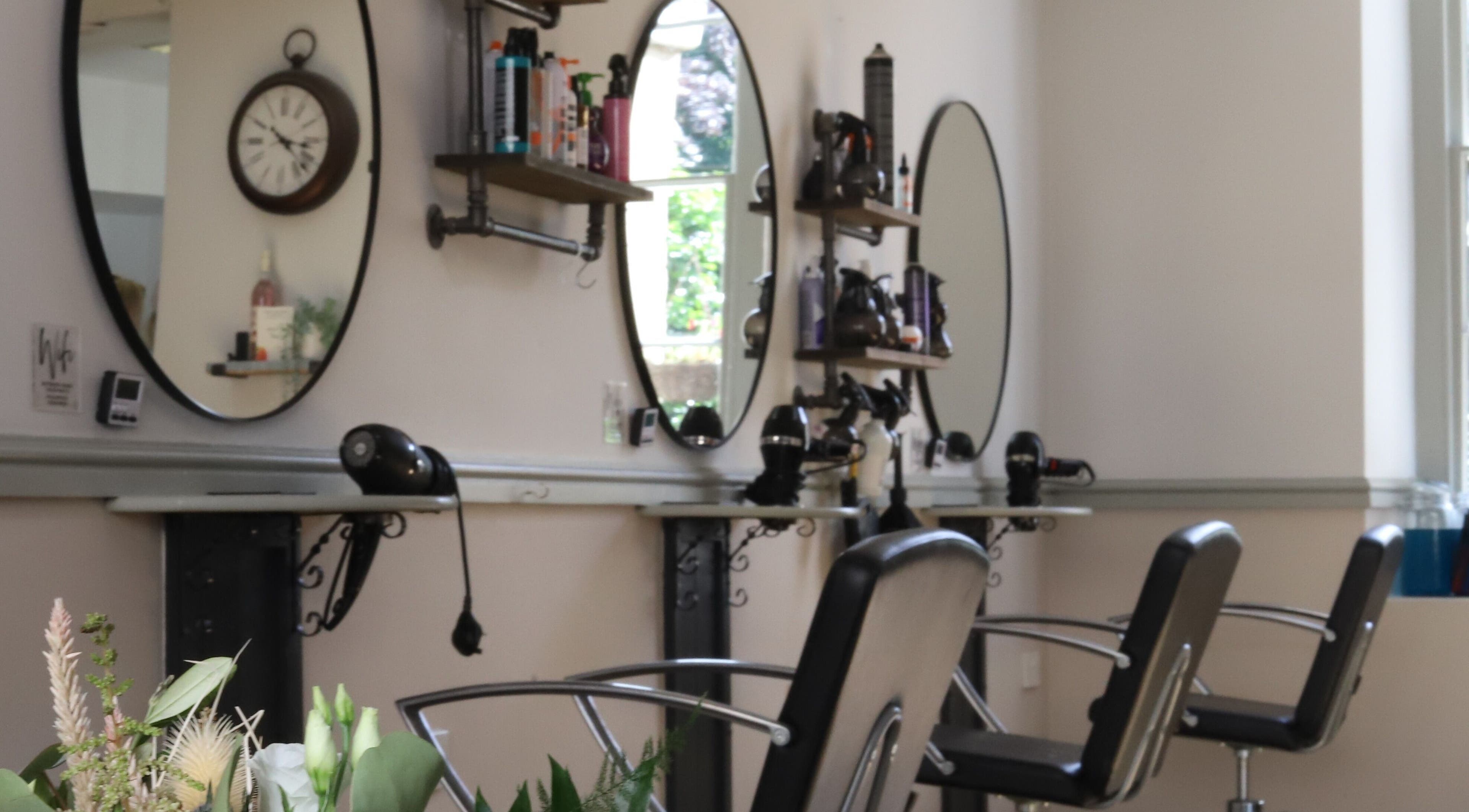 Stylish interior of Strawberry Fields Hair Design in Corsham, England, GB showcasing elegant styling stations.