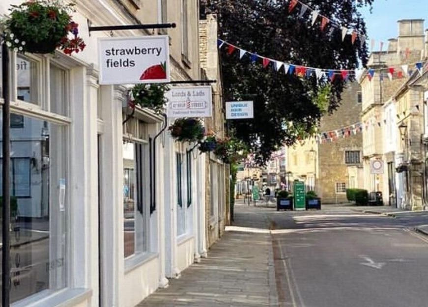View of Strawberry Fields Hair Design on a quaint street in Corsham, England, GB, showcasing local charm.