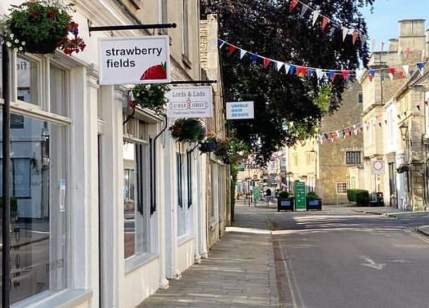 View of Strawberry Fields Hair Design on a quaint street in Corsham, England, GB, showcasing local charm.