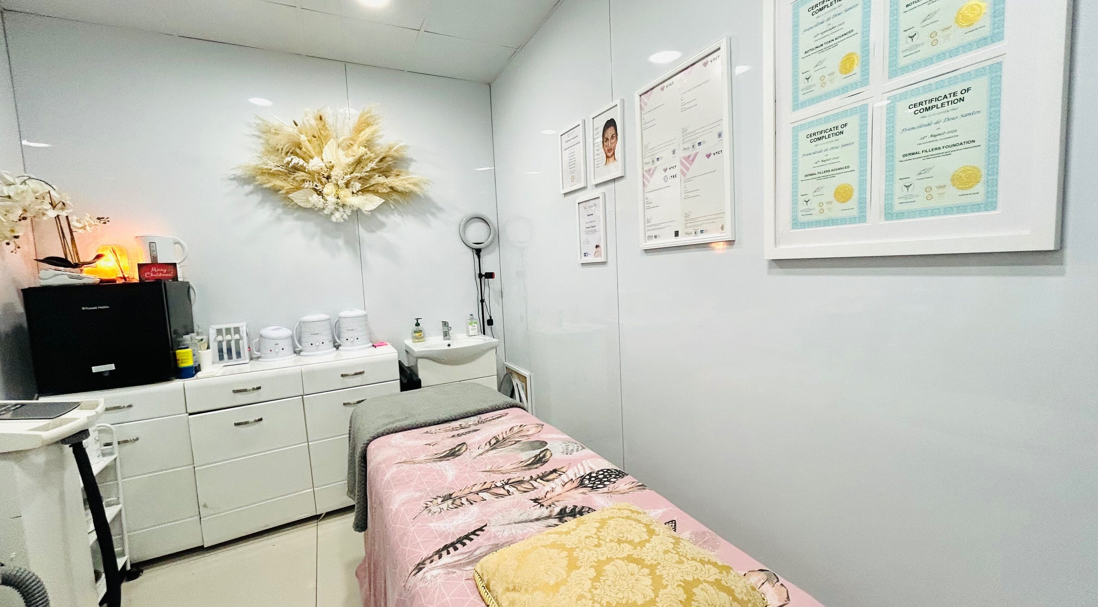 Cozy treatment room at Silk and Glow Skincare in London, England, GB featuring elegant decor and certifications.