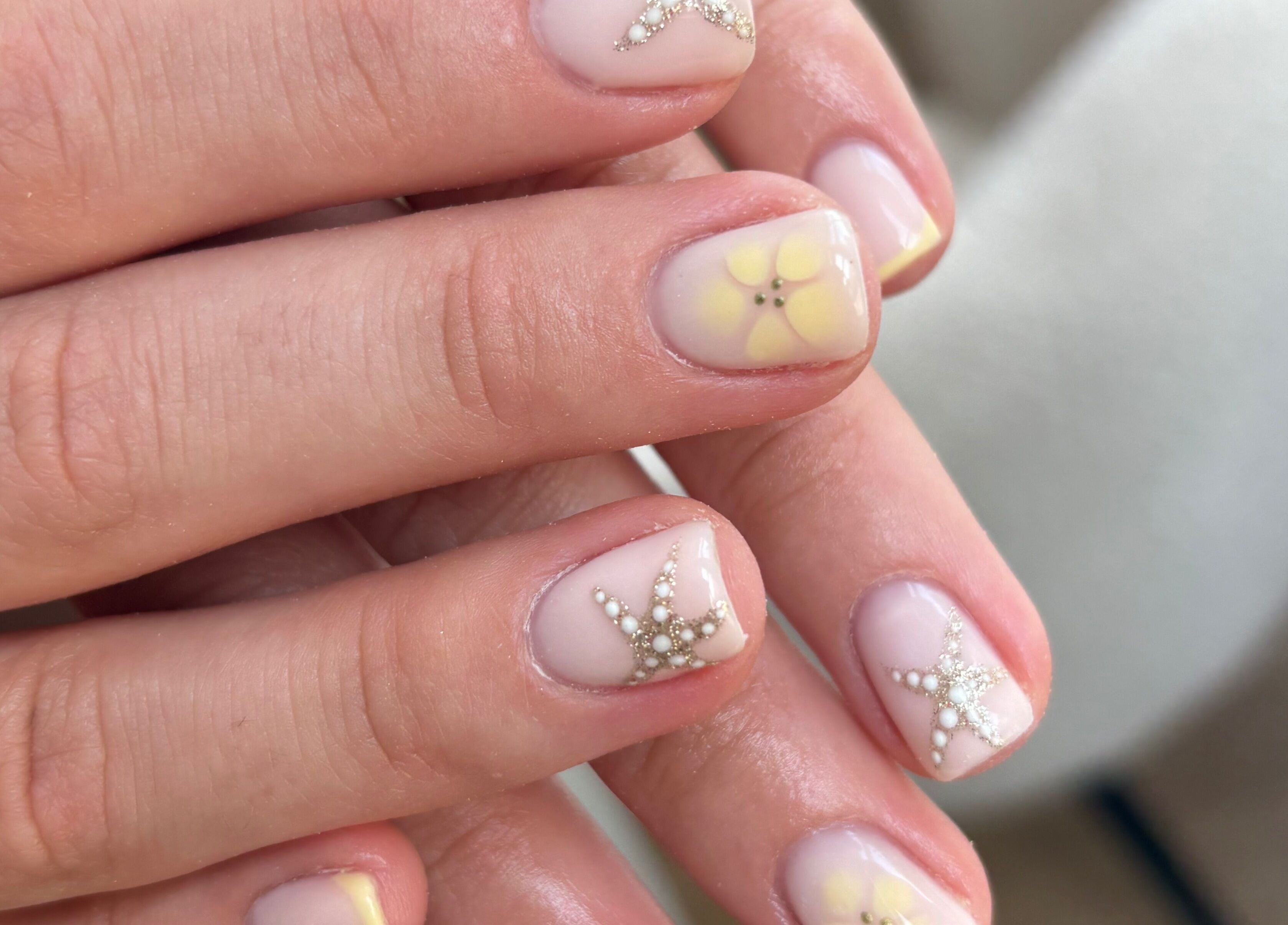 Elegant nail art with floral and star designs at Blended Beauty Rugeley, Rugeley, England, GB.