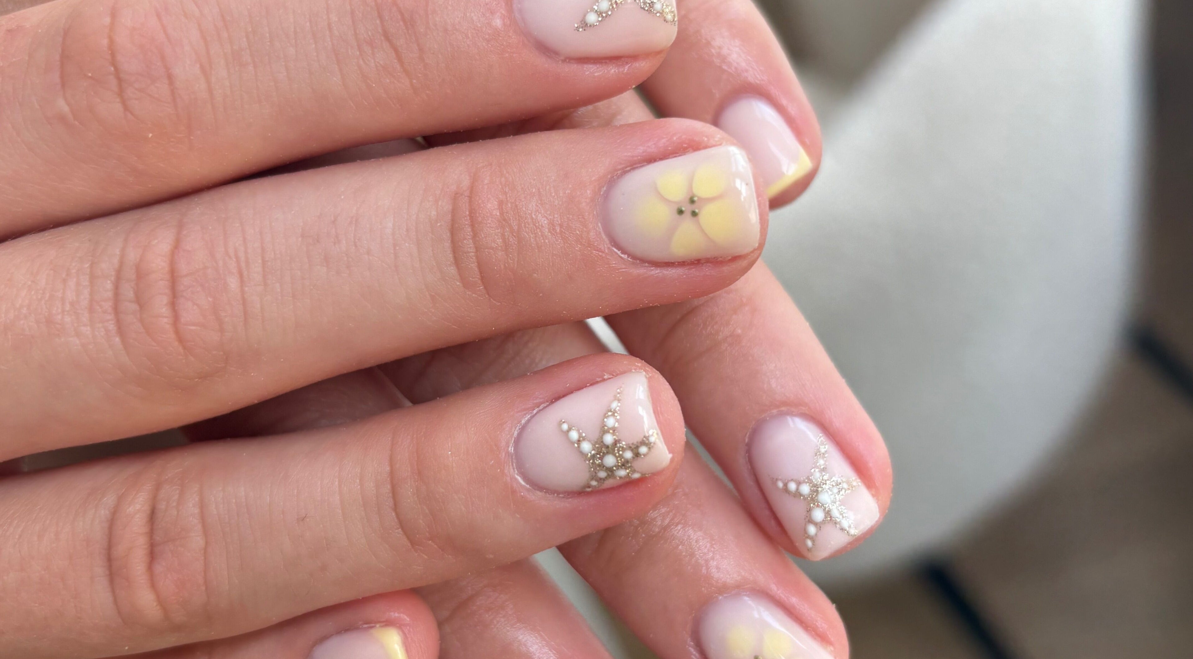 Elegant nail art with floral and star designs at Blended Beauty Rugeley, Rugeley, England, GB.