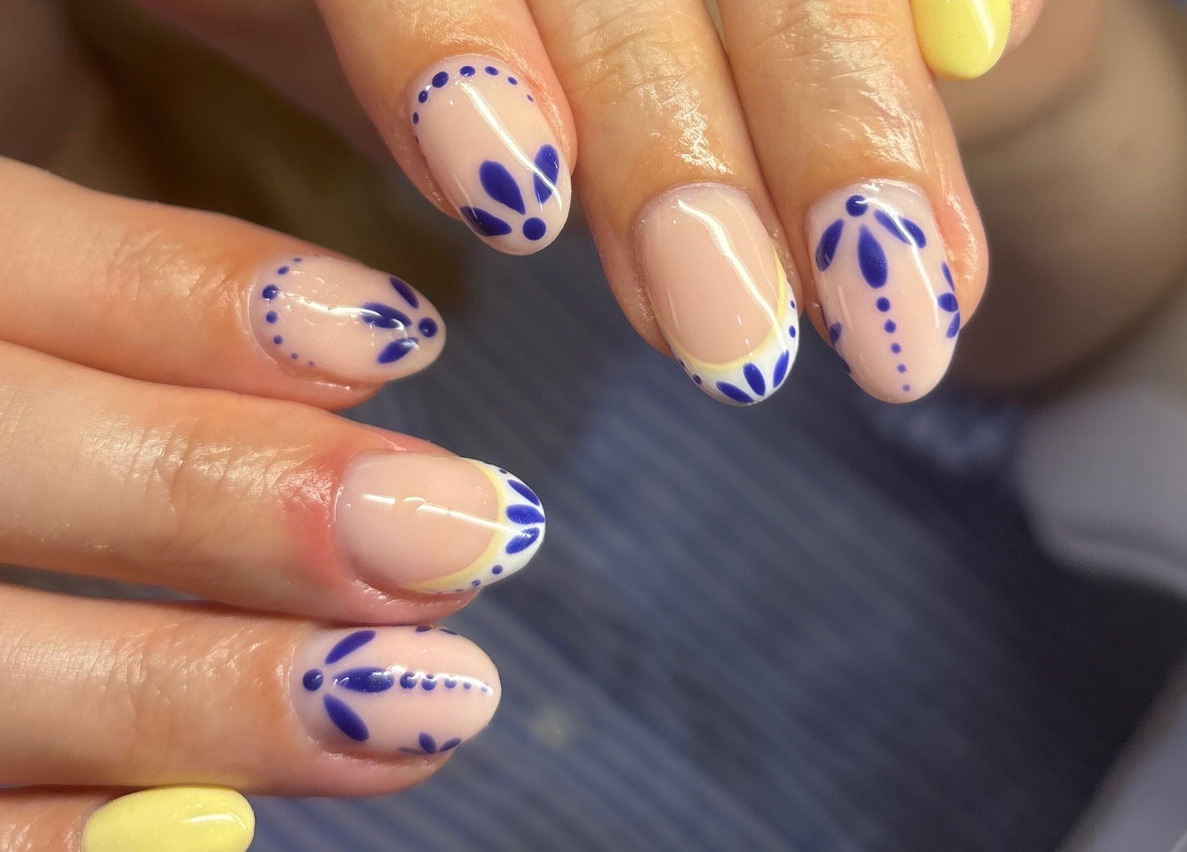Intricate blue and yellow nail designs at Blended Beauty Rugeley, Rugeley, England, GB.