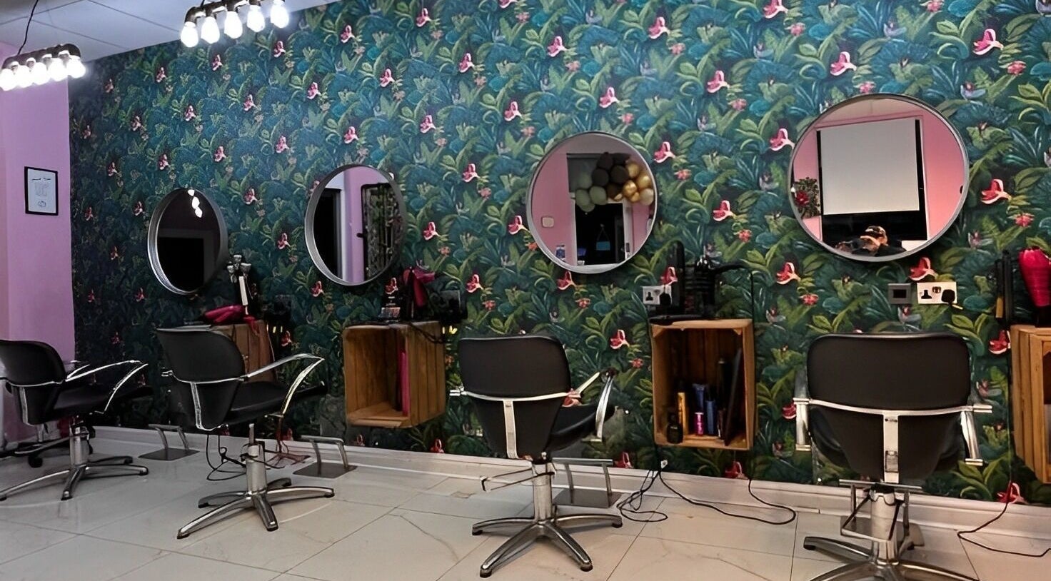 Chic interior of Betsy Rosa Hair & Beauty in Liversedge, England, GB featuring floral decor and styling chairs.