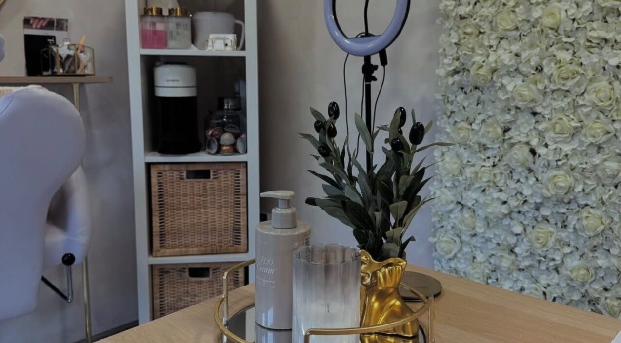 Chic beauty desk setup at Beauty by CO B, Dronfield, England, GB with floral décor and skincare products.