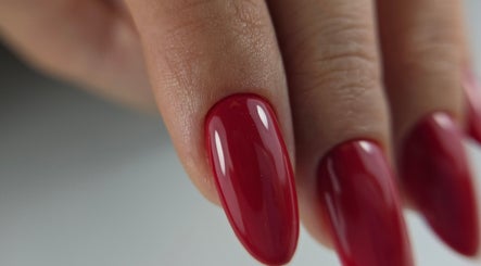Close-up of red manicure by Nail Design by Maja, Olney, England, GB, showcasing glossy finish.