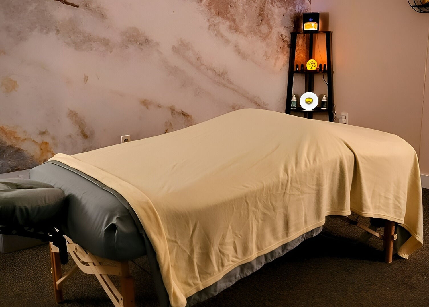 Massage table in tranquil room at Open Your Heart, Saline, Michigan, US offering a relaxing spa experience.