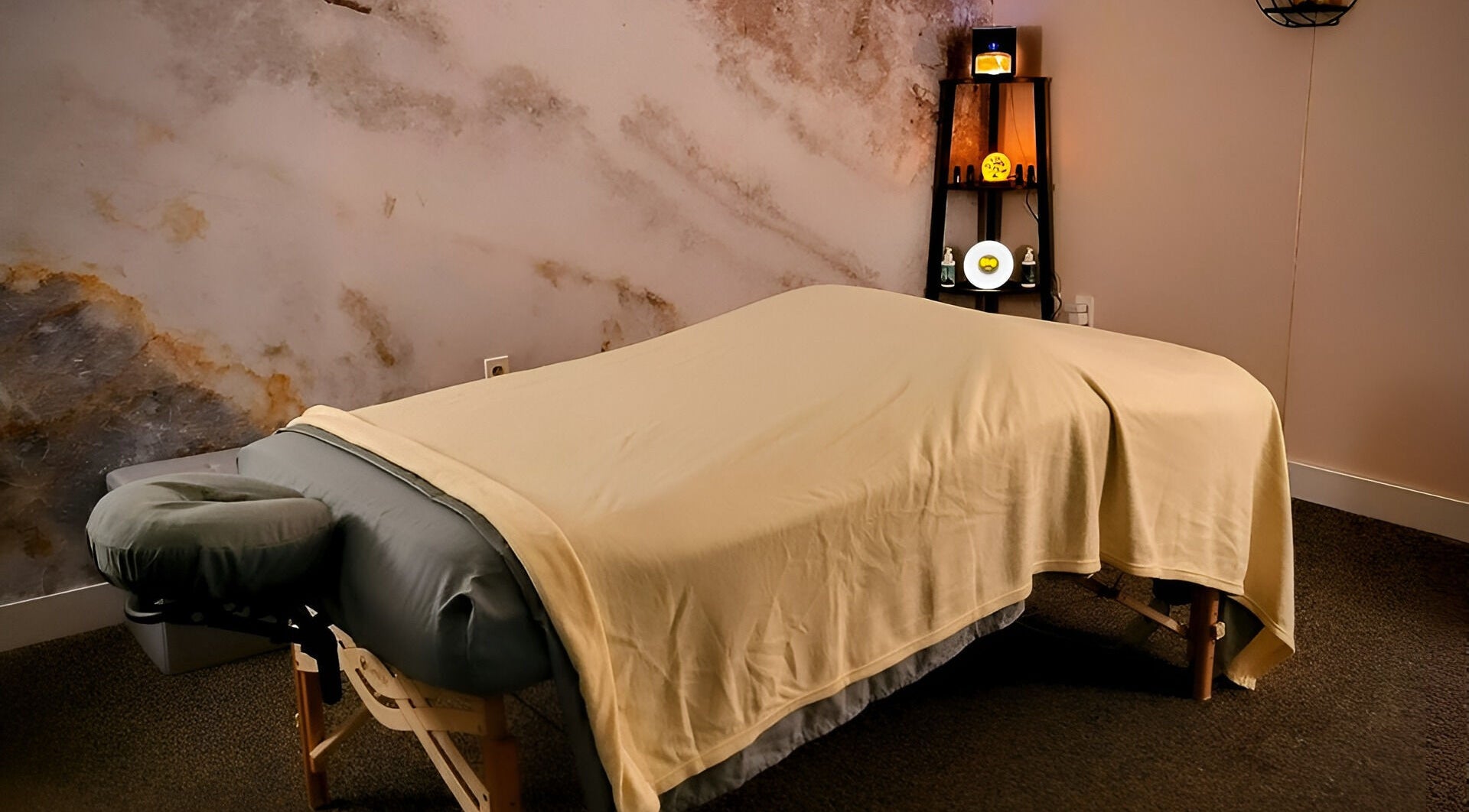 Massage table in tranquil room at Open Your Heart, Saline, Michigan, US offering a relaxing spa experience.